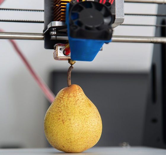 3D printer printing a pear